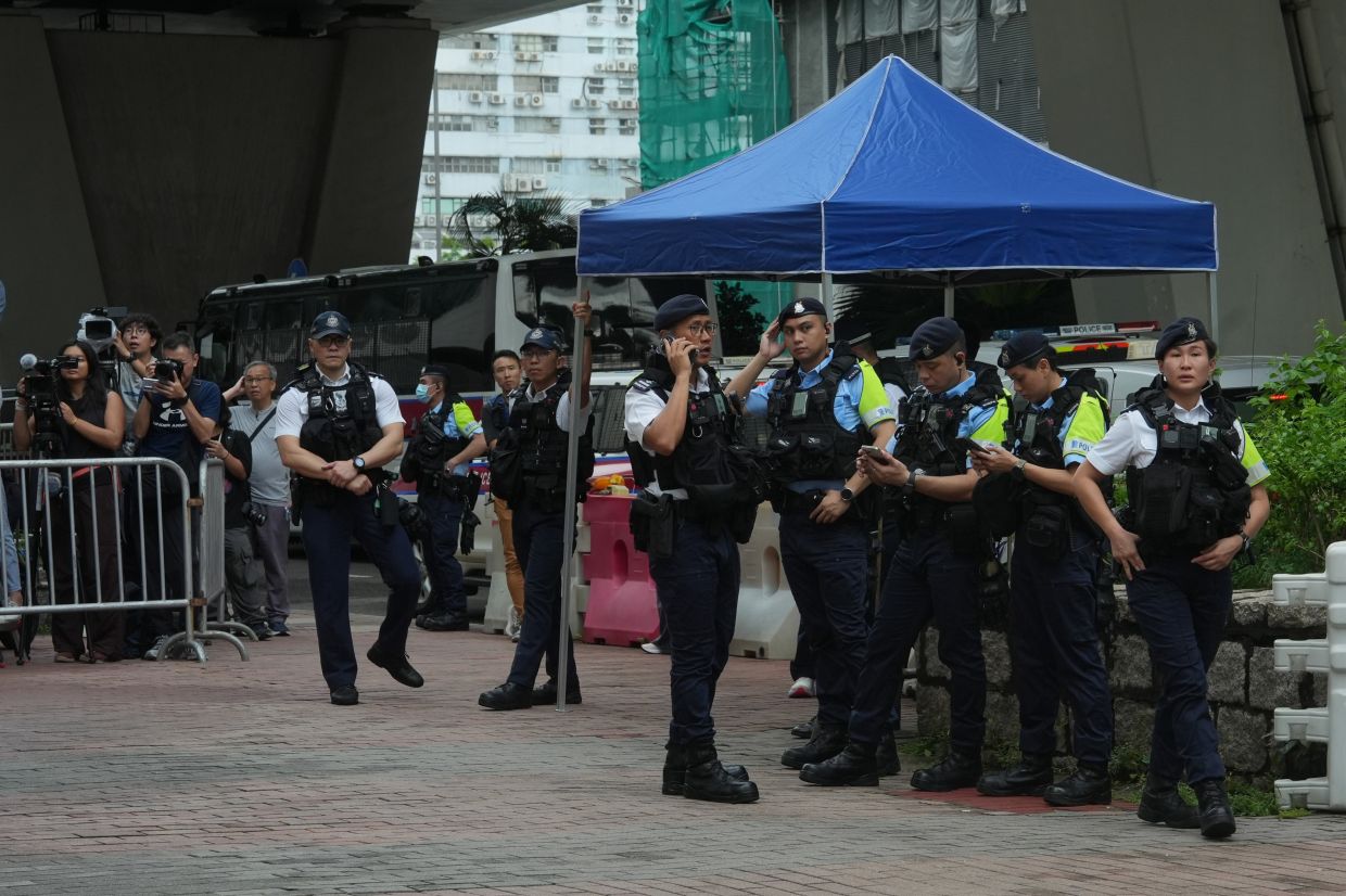 Hong Kong woman detained for T-shirt message as court delivers guilty verdict against democracy activists