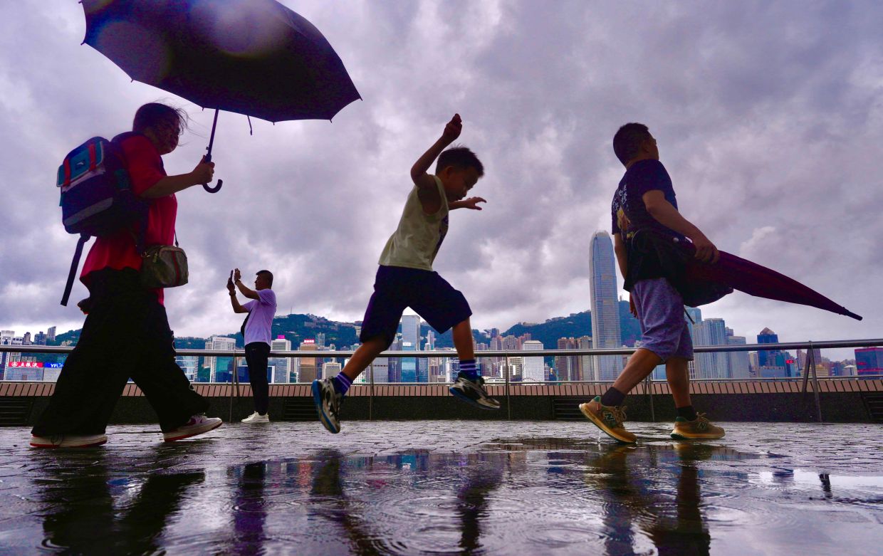 Monsoon rains break Hong Kong's historic heat spell after record-shattering summer