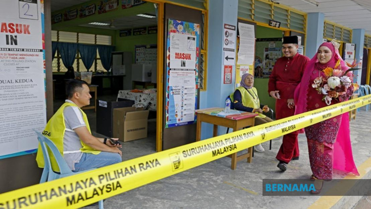 Young Bride Casts Vote in Traditional Red Bridal Attire at Negeri Sembilan Election