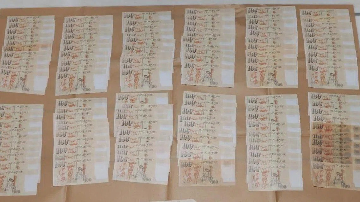 Two Chinese nationals charged in Singapore currency counterfeiting case